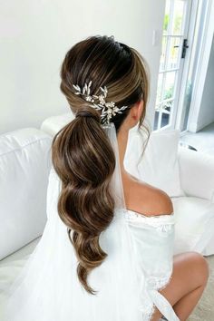 a woman sitting on top of a couch wearing a wedding dress