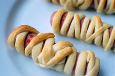 hot dogs wrapped in bread on a plate