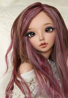 a doll with long pink hair and big eyes