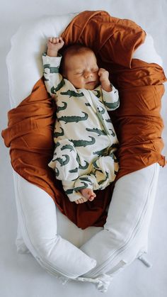 a baby is laying down on a pillow