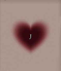 a heart shaped object with the letter j in it's center and blood splattered on top