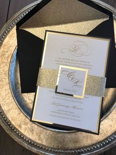 the wedding stationery was done in black, gold and white with glitter accents on it