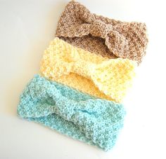 three crocheted headbands with bows on them sitting next to each other