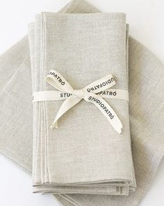 folded napkins with ribbon tied around them