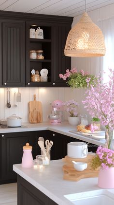 a kitchen filled with lots of counter top space and flowers in vases on the counters