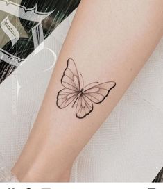 a small butterfly tattoo on the arm