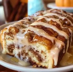 a close up of a plate of food with cinnamon bundt cake on it and drizzled with icing