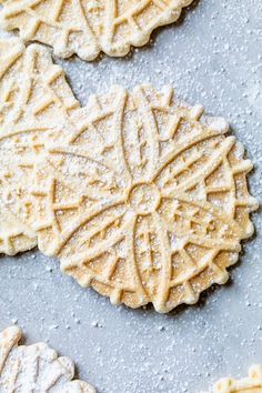 some cookies are sitting on a table with powdered sugar