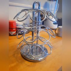 a metal rack with circles on it sitting on top of a wooden table