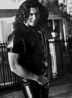 black and white photograph of a man in leather pants