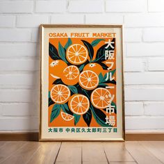 an orange fruit market poster hanging on a brick wall