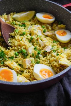 a pan filled with rice and eggs on top of a table