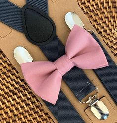 Dusty Rose Bow Tie & Dark Grey Suspenders Set Our bow ties and suspenders are the perfect choice for weddings, groomsmen, family photos, ring bearer outfits, birthday celebration or any other special occasion.**Please Specify** Bow Tie Only (w/ Clip or Neck Strap), Suspenders Only, or Bow Tie Only & Susp (Bow Tie and Suspenders) SUSPENDERS- One Pair of our Quality Suspenders BOW TIE - One Bow Tie on White Adjustable STRAP or Alligator CLIP*Sizing: Please Check Measurements Before Ordering *Note: Dusty Rose Bow Tie, Suspenders Ring Bearer, Ring Bearer Outfits, Outfits Birthday, Bold Bohemian, Baby Suspenders, Grey Suspenders, Tie And Suspenders, Suspenders For Boys