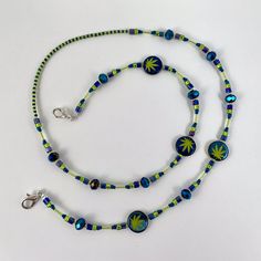 Each bead strand is created to hang comfortably around your neck and accessorize your outfit with style. Often used as eyeglass holders or badge holders, you can also wear solo as a necklace or hang other objects like pens or keys.  These bead strands run between 28"to 32" long, with durable metal lobster clasps on each end. They clip right onto a badge or you can add an extra attachment for eye glasses. We use both glass beads and natural stones that we string on a strong steel bead stringing wire. We double crimp the strand ends to make sure the beads are secure and durable to wear and enjoy everyday. How we make these... As we carefully lay out bags of all the beads, we look for big and small shapes that will complement one another in a pattern or design. With tweezers, we then lay out Adjustable Beaded Blue Lanyards, Adjustable Blue Beaded Lanyards, Green Beaded Necklace With Adjustable Chain, Adjustable Blue Glasses Chains With Colorful Beads, Handmade Adjustable Blue Glasses Chains, Adjustable Blue Beaded Necklace, Adjustable Blue Beaded Necklaces, Adjustable Beaded Chain Lanyard For Gift, Adjustable Green Beaded Necklaces With Lobster Clasp