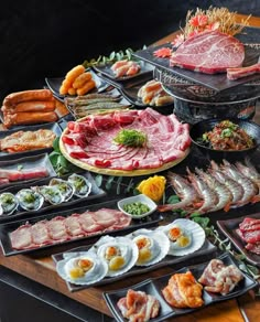 an assortment of meats and other foods on display