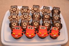 there are many cupcakes decorated like cars on the plate and in the shape of trucks