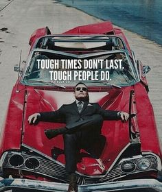 a man sitting on top of a red car with the words tough times don't last tough people do