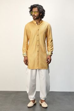 Yellow front open kurta with thread embroidery all over and printed cuffs. Paired with a white dhoti pant. - Aza Fashions Ceremonial Cotton Silk Kurta For Navratri, Ceremonial Chikankari Traditional Wear In Cotton Silk, Ceremonial Cotton Silk Churidar For Eid, Ceremonial Churidar In Cotton Silk For Eid, Ceremonial Cotton Silk Kurta With Traditional Drape, Traditional Wear With Pallu And Straight Kurta, Ceremonial Chikankari Embroidery Kurta For Navratri, Navratri Ceremonial Kurta With Chikankari Embroidery, Ceremonial Cotton Silk Sherwani For Festive Occasions