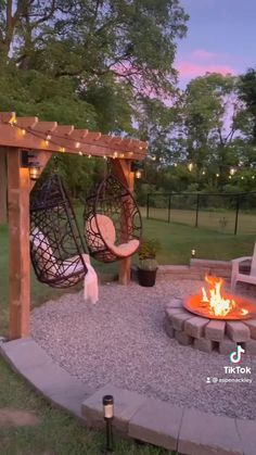 an outdoor fire pit with swings and chairs