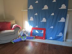 a child's room with a blue curtain and toys on the floor in front of it