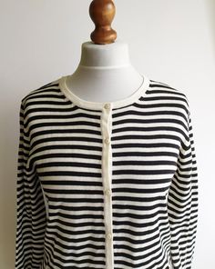 A lovely vintage striped cardigan. Long-sleeved with a round neck and buttons down the front. Cotton fabric, very comfortable. It gives a lovely nautical or French look. Very classic.Size: women's MMeasurements of it laying flat:armpit to armpit- 52cm/ 20.4inlength- 67cm/ 26.3insleeve- 64cm/ 25.1inFabric: 50% cotton, 50% acrylicExcellent vintage conditionCheck out my other items! https://www.etsy.com/shop/naamii Striped Long Sleeve Cardigan For Layering, Spring Striped Workwear Cardigan, Spring Long Sleeve Cardigan With Striped Collar, Striped Buttoned Cardigan For Spring, Striped Long Sleeve Cardigan With Buttons, Striped Long Sleeve Sweater With Buttons, Classic Striped Winter Cardigan, Striped Cotton Long Sleeve Cardigan, Striped Long Sleeve Cotton Cardigan