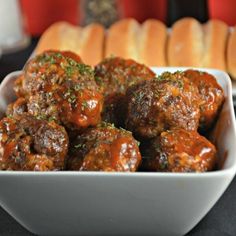 some meatballs in a white bowl on a table