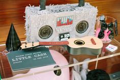 there is a cake made to look like an old school cassette player and other items