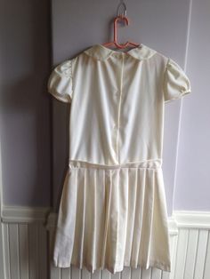 "Circa late 1960's early 1970's vintage dress for a young girl. Beautiful little dress, dropped waist Chemise style Marked a size 12. Measurements are; Armpit to armpit13\" Shoulder to shoulder14\" Waist13\" Length25\" Sleeves3\" Feel free to convo me with any further questions. Thank you for your interest." Pleated School Dress For Spring, Spring School Pleated Dress, Spring Pleated School Dress, Spring School Dress With Peter Pan Collar, Retro Short Sleeve School Dresses, Fitted Short Sleeve Dress For School, Vintage Dresses For School In Spring, Classic White Vintage Dress With Short Sleeves, Classic School Dresses For Spring