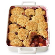 a casserole dish filled with fruit and biscuits