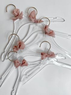 four pairs of scissors with pink flowers on them and some hair clips attached to them