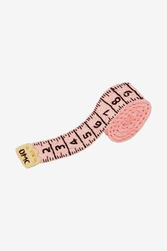 a pink measuring tape with the word don't stop written on it