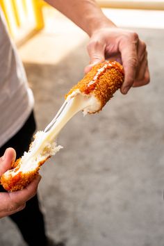 a person holding a piece of food in their hand