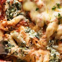 a close up of a plate of food with pasta and spinach