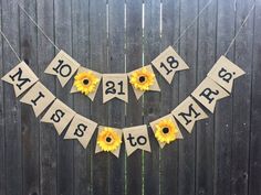 sunflowers are hanging from a banner that says welcome to spring