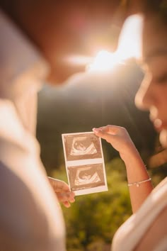 a man and woman are holding up pictures