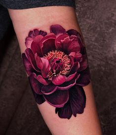 a close up of a flower on a person's arm with the image of a peony