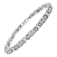 Elevate your fashion game with this stylish bracelet that’s equal parts style and sophistication. The Sterling Silver chain is accented with natural diamonds that total up to 1/10 cttw, set in a miracle setting. The 13 round stones are encased in a frame design that sets it apart from the typical tennis bracelets. Measuring at 7.25 inches, the fashionable piece is cinched together with a lobster claw clasp.  Product features: Diamond Type: Natural White Diamonds Diamond Count: 13 Round-Cut Diamo Stylish Bracelet, Diamond Settings, Bracelet Clasps, Diamond Clarity, Round Cut Diamond, Link Bracelets, Sterling Silver Bracelets, Diamond White, Sterling Silver Chains