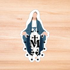 an image of the virgin mary sticker on a wooden surface