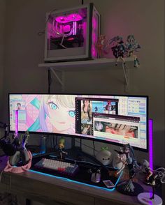 two computer monitors sitting on top of a desk next to a keyboard and headphones