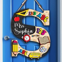 a door hanger with the number 5 made out of school supplies on it's side