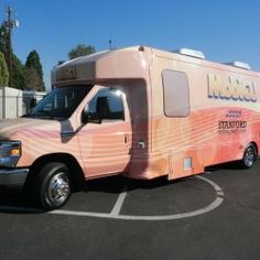 a pink truck parked in a parking lot