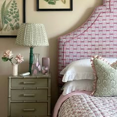 a bedroom with pink and green decor on the walls