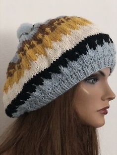 a mannequin head wearing a knitted hat with multicolored stripes on it