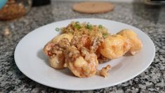 a white plate topped with meat and rice