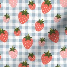 a blue and white checkered table cloth with strawberries on it