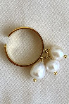 Adjustable Pearl ring, charm ring to my daughter. Old Money jewelry by MarinaMiJewelry. Freshwater pearls cocktail ring, trendy jewelry. This ring features three freshwater pearls delicately hanging and gracefully swaying with the movement of your hand. The enchanting pearls add a touch of elegance and sophistication, making this ring a charming accessory that catches the eye with its graceful dance. Elegant Pearl Chain Ring, Pearl Drop Open Ring, Pearl Drop Open Ring Jewelry, Adjustable Pearl White Ring With Pearl Drop, Elegant Adjustable Pearl Ring With Charm, Gift Pearl Ring With Pearl Charm, Pearl Ring With Pearl Charm As Gift, Adjustable Pearl White Ring With Pearl Charm, Adjustable Elegant Pearl Drop Ring