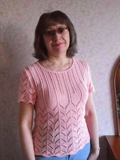 a woman standing in front of a wall with a clock on it's side