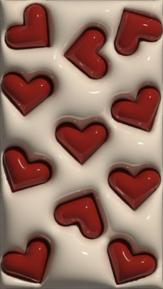 chocolate hearts are arranged in the shape of heart shapes on a white background with red accents