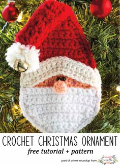 a crocheted santa ornament hanging from a christmas tree