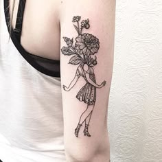 a woman with a flower tattoo on her arm